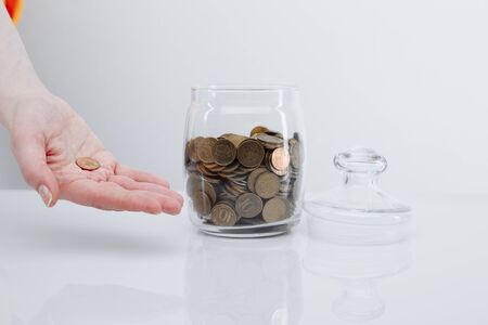 Donation concept. Box with coins on the white table.の写真素材