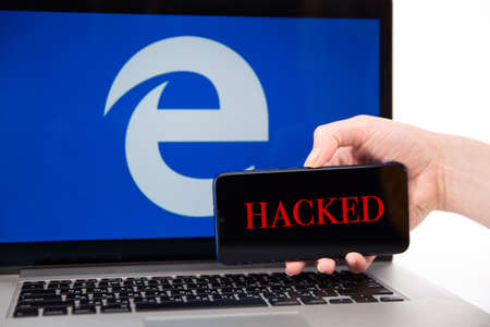 Tula Russia 12.02.2020 Hacked Internet Explorer on the phone and laptop concept.