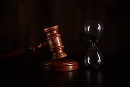 Judge gavel and hourglass. Law and time conceptの写真素材