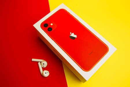 Tula Russia 16.01.20: Apple AirPods wireless Bluetooth headphones for Apple iPhone. New Apple Earpods Airpods on a blue background. Copy spaceのeditorial素材