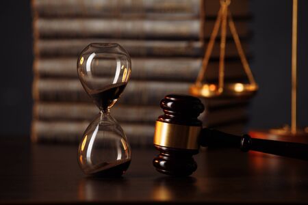 Judges gavel, scales of justice, books and hourglass on wooden table. Law conceptの写真素材