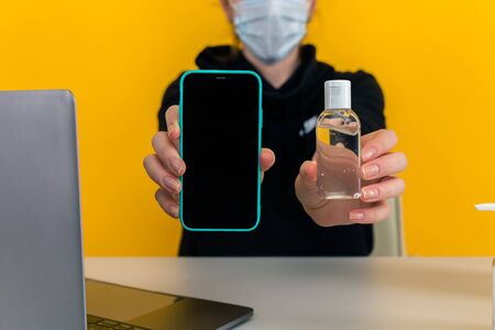 Desinfecting phone concept. Woman cleaning mobile.