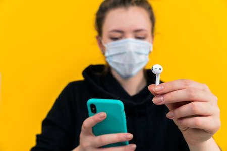 Tula Russia 13.04.2020 closeup picture of woman with airpods.のeditorial素材
