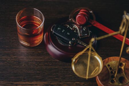 Whiskey with car keys and handcuffs. Concept for drinking and drivingの写真素材