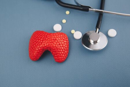 Thyroid with stethoscope and medicines on the grey table.の写真素材