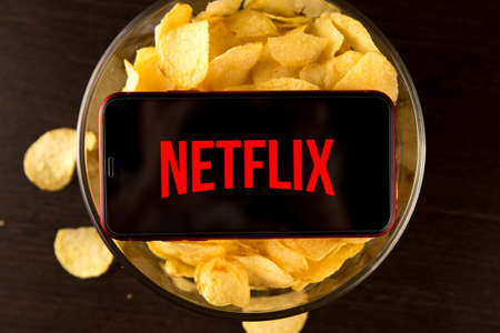 Tula Russia 07.05.2020 Netflix on the phone screen and chips.のeditorial素材