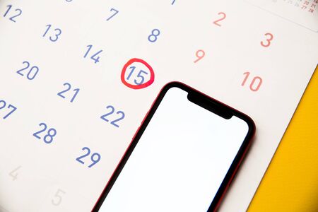 Feminine calendar with reminder ovulation in graph and smartphone. Tracking the menstrual cycle and ovulation conceptの写真素材