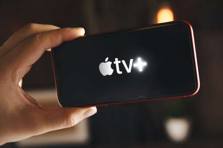 Tula Russia 07.05.2020 Apple TV on the phone screen in the man's hand