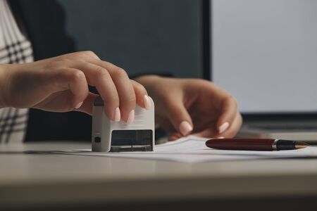 Female notary stamping agreement, company secretary, official document, validityの写真素材