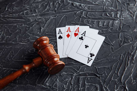 Law and rules for online gambling concept, judge gavel with playng cards on grey background.の写真素材