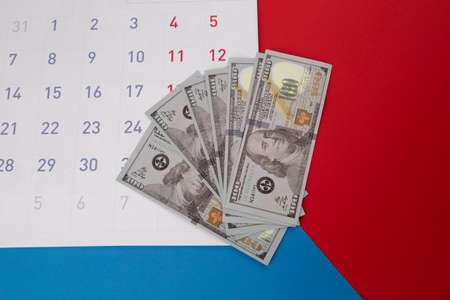 Calendar and dollar banknotes on colorful backgroundの写真素材