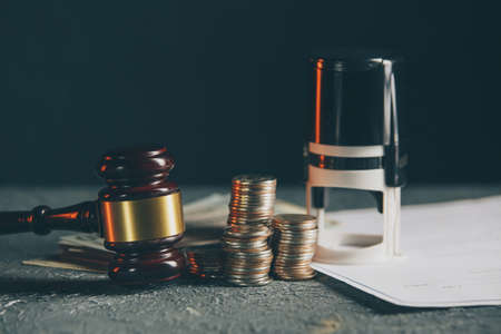 Miniature house with money and tax papersの写真素材