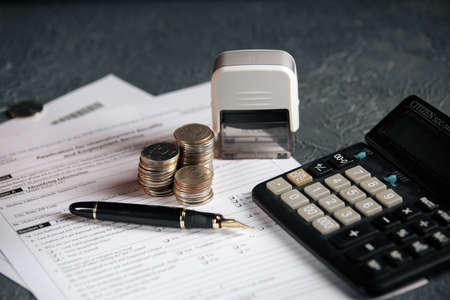 Saving stack coins money concept,graph,chart document and pen on desktop desk in hipster office,copy...
