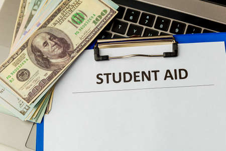 Financial help for student statement. Money on the laptop.