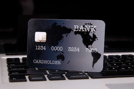 A Man Shopping Online Using Laptop With Credit Cardの写真素材