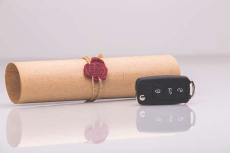 pplication form for car loan, pen and key on wooden table, close up viewの写真素材