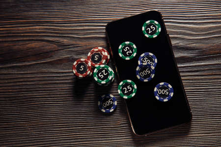 Poker chips and smartphone. Online casino conceptの写真素材