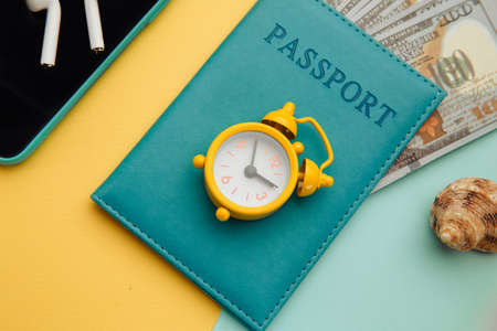 Outfit and accessories of traveler on yellow blue background close-up. Travel concept. Overhead view of travelers accessoriesの写真素材