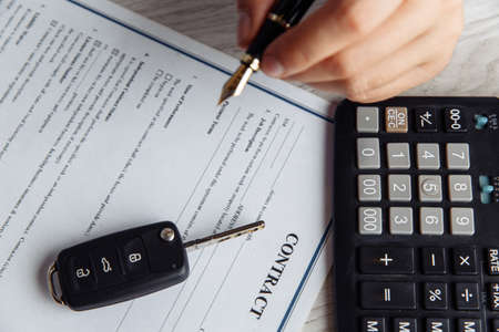 Close up shots hands of client signing car lease formの写真素材