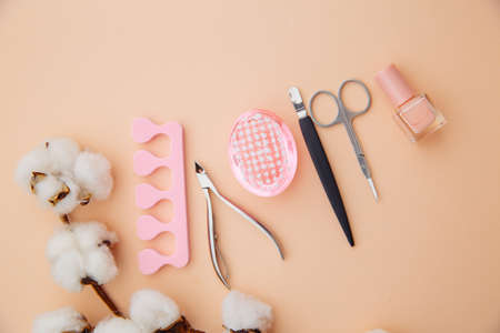 Beauty care concept. A set of professional tools for manicure and pedicure on pink backgroundの写真素材