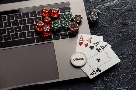 Chips, dices and playing cards with aces for poker online or casino gambling. Online casino conceptの写真素材