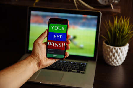 Man watching football match online broadcast on his laptop waiting for winning resultの写真素材