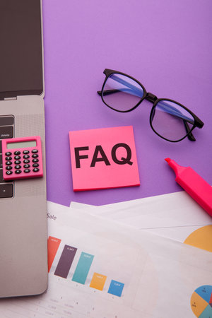 Sticky note with word FAQ on pink table. Frequently asked question concept. Vertical imageの写真素材