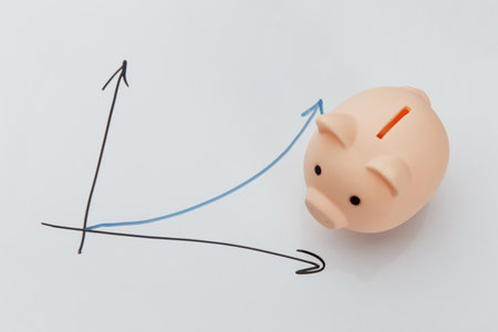 Piggy bank on a blackboard with growing chartの写真素材