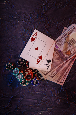 Online casino Ñoncept. Dollar banknotes, stucks of gambling chips and aces. Vertical image