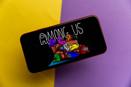 Tula, Russia - November 11, 2020: Among Us logo on iPhone display