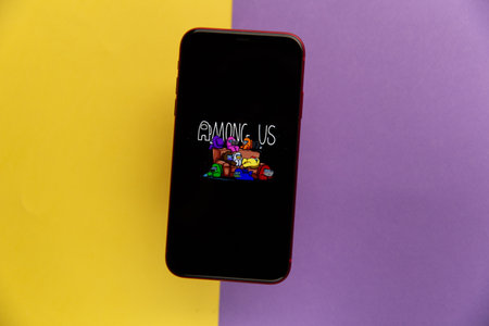 Tula, Russia - November 11, 2020: Among Us logo on iPhone display