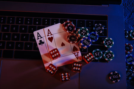 Casino play online. Playing chips, cards and dices on laptops keyboard. Top viewの写真素材