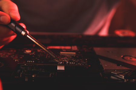 PC technology .Computer repair shop. Engineer performing laptop maintenance. Hardware developer...