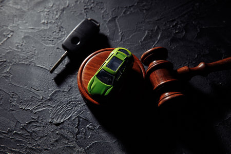 Wooden hammer and toy car with car keys. Insurance, court caseの写真素材