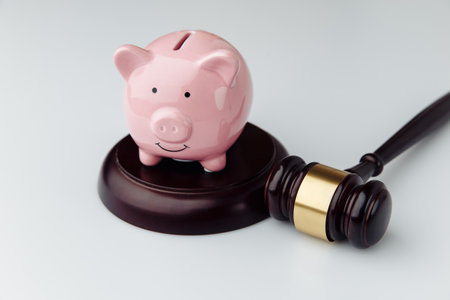Judge gavel and pink piggy bank on a white desk. Loan and business conceptの写真素材