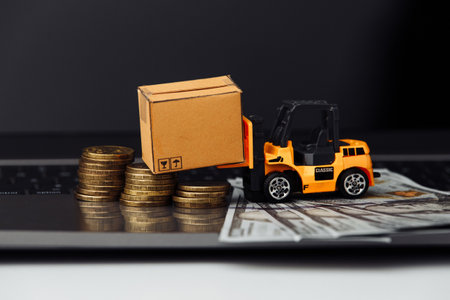 Mini model of forklift with boxes on laptop close-up. Logistics and wholesale conceptの写真素材