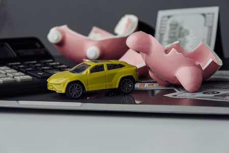 Car and dollars banknote with broken piggy bank background. Insurance concept. Saving moneyの写真素材