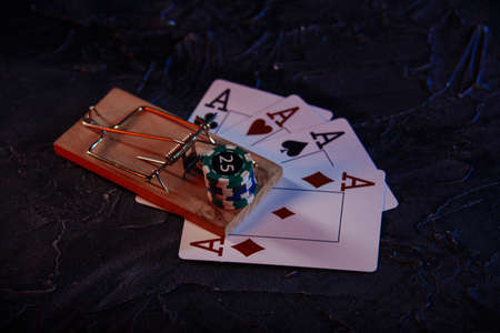 Mousetrap on playing cards and casino chips. Game addiction conceptの写真素材