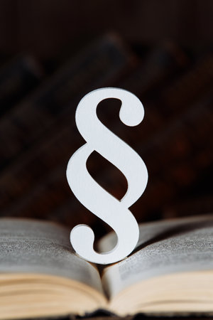 Paragraph sign and book in a courtroom, vertical imageの写真素材