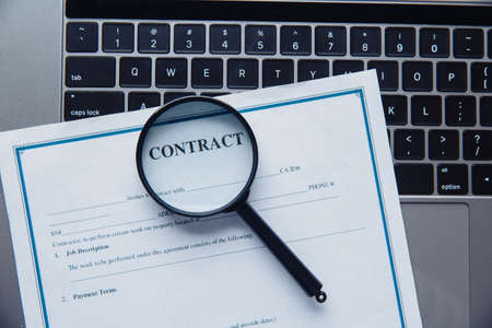 Magnifying glass and contact on a laptop. Top viewの写真素材