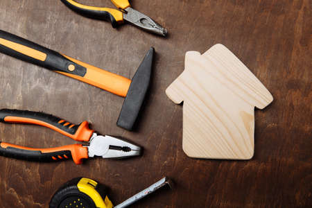 Set of different tools for repair and house on a wooden background. Top viewの写真素材