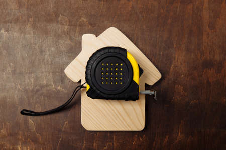 Roulette and house on a wooden background