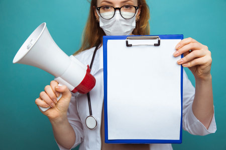 Medical news. Woman holding tablet in the blue cabinetの写真素材