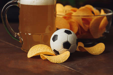 Beer glass and chips close-up. Football fans conceptの写真素材