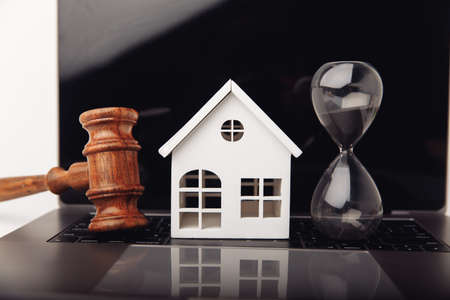 House and hourglass. Loans for real estate or buy a new house in the future