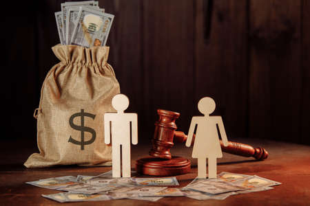 Bag of money, dollar banknotes, people and the judges hammer. The concept of divorce