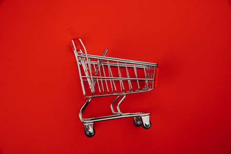 Shopping cart isolated on redの写真素材