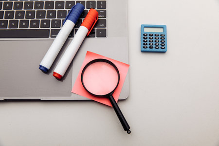 Office workplace. Stickers, calculator and magnifying glass. Business and finance concept