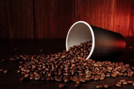 A coffee paper cup with coffee beans