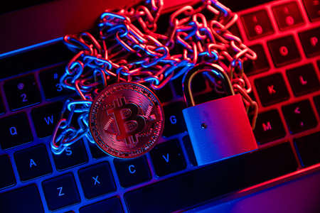 Bitcoin with chain and padlock. Conceptual photography of financial fraudの写真素材